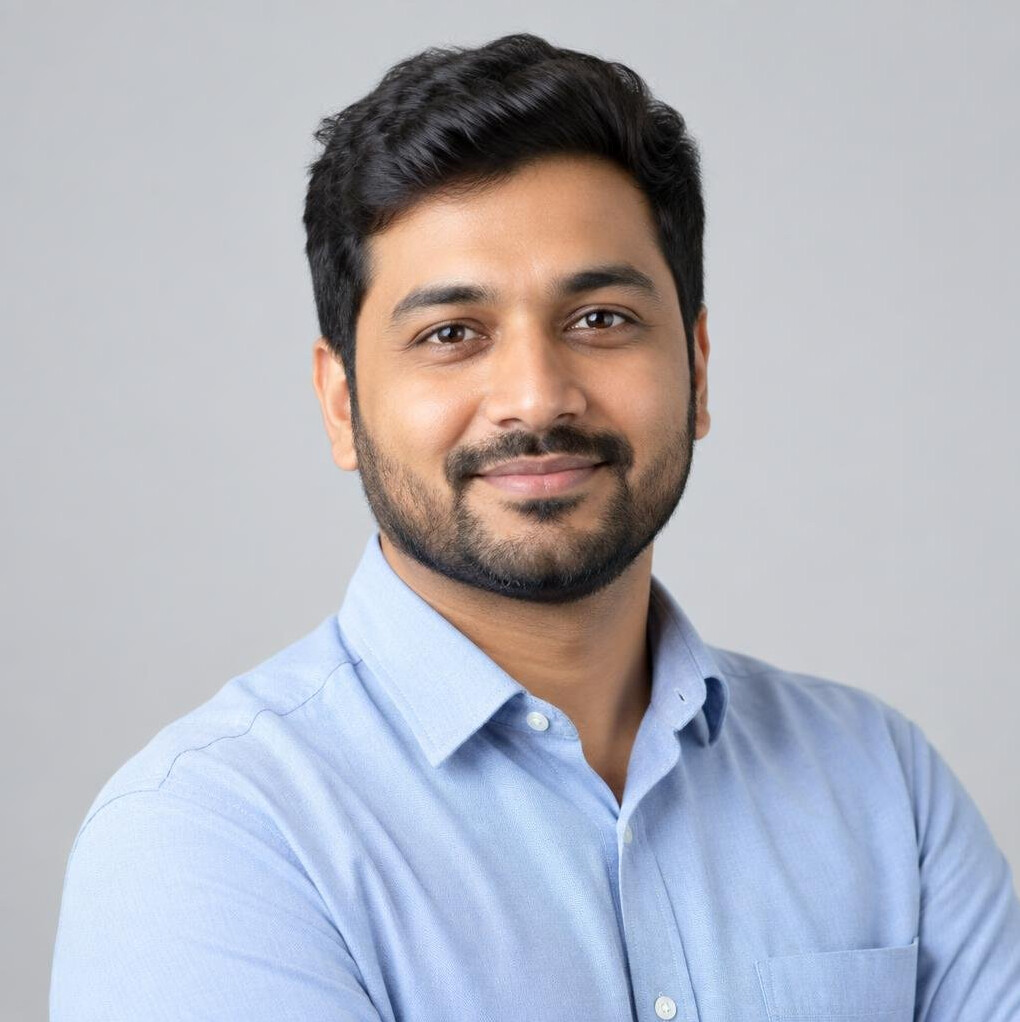 Studio portrait of a man in his 30s with a beard, business casual attire