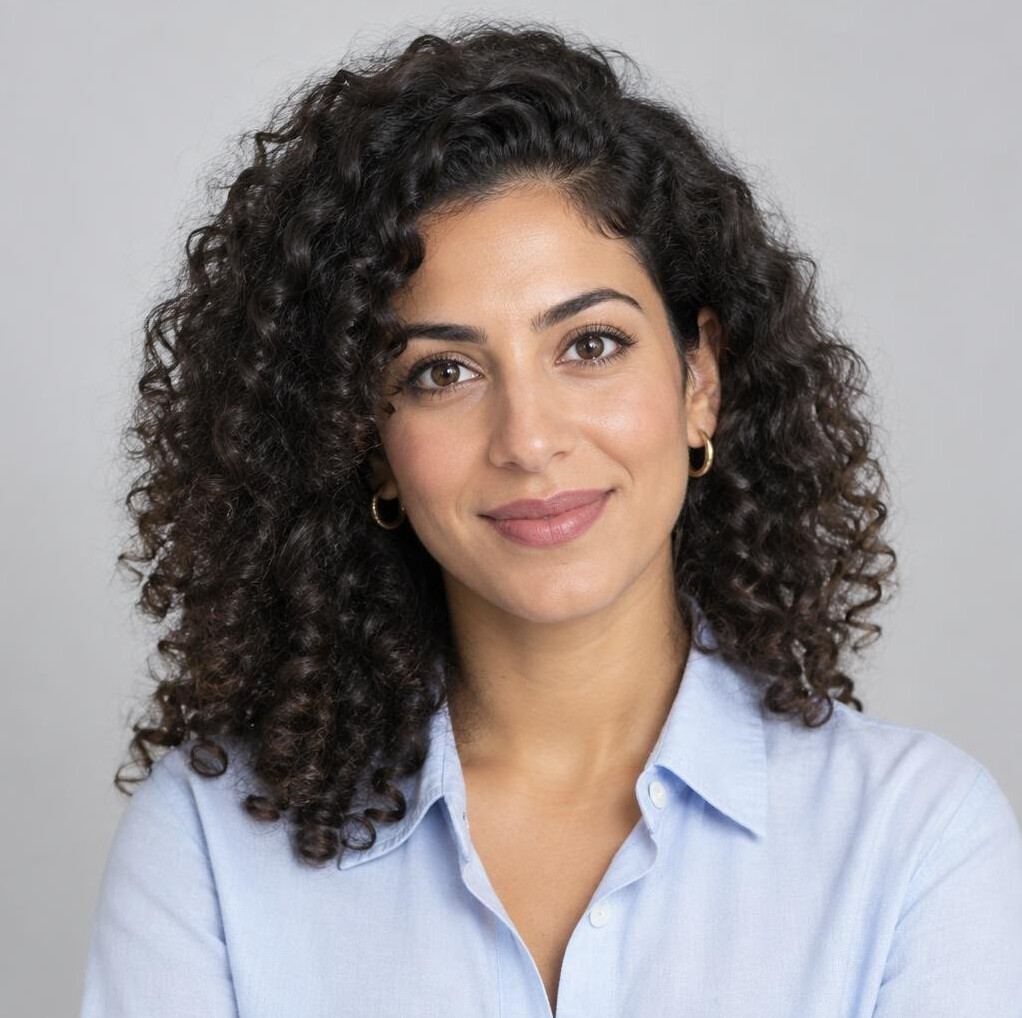 Studio portrait of a young woman data journalist with curly hair