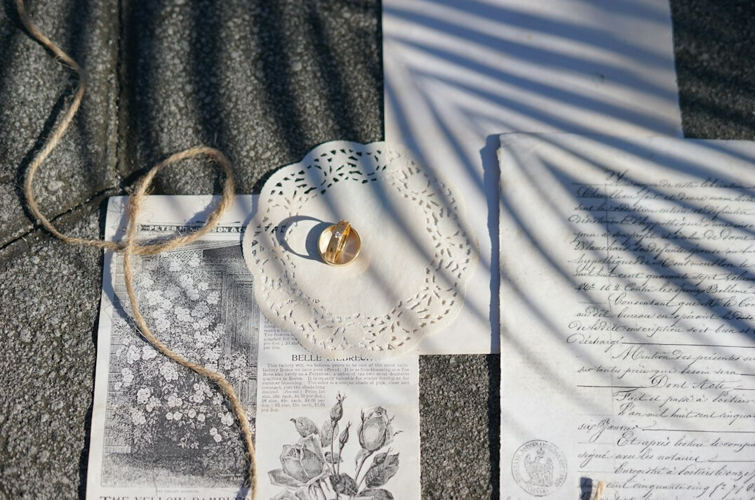 Stack of printed documents with a pen and magnifying glass